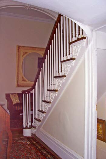Distant view of banisters and Federal style acanthus leaf pattern on side of staircase in Anthony Rutgers Livingston House. 