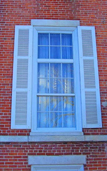 Federal Style Triple Hung Six over Six Window with Louvered Shutters